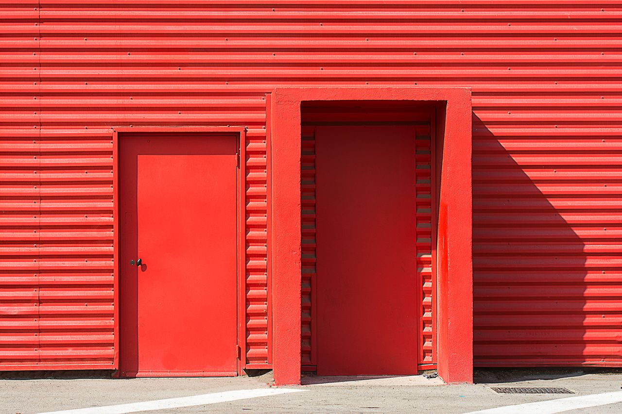 Crafting Captivating Headlines: Your awesome post title goes here A striking image of a red corrugated metal building featuring two red doors, perfect for modern architecture projects.